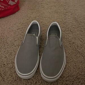 Grey and white slip on vans